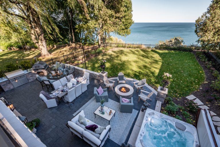 Patio kitchen - large transitional backyard concrete paver patio kitchen idea in Milwaukee with no cover