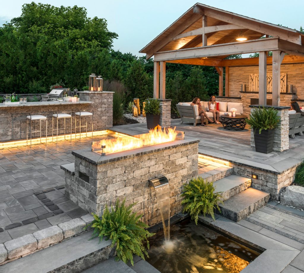 Patio kitchen - large transitional backyard concrete paver patio kitchen idea in New York with a pergola