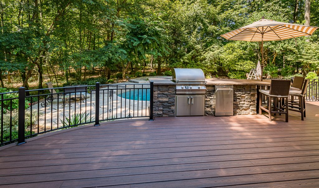 Patio kitchen - large transitional backyard patio kitchen idea in New York with decking and no cover
