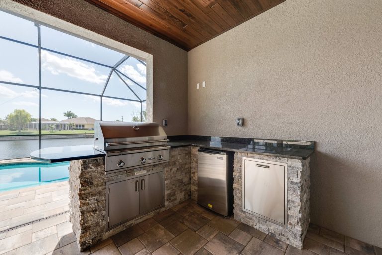 Patio kitchen - large transitional backyard patio kitchen idea in Other with a roof extension