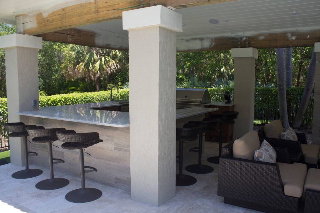 Patio kitchen - large transitional backyard stone patio kitchen idea in Miami with a gazebo