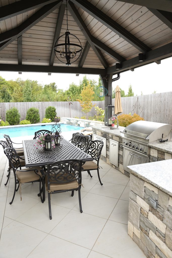 Patio kitchen - large transitional backyard tile patio kitchen idea in Other with a gazebo
