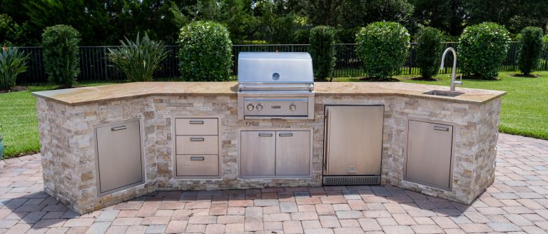Patio kitchen - mediterranean backyard brick patio kitchen idea in Miami with no cover