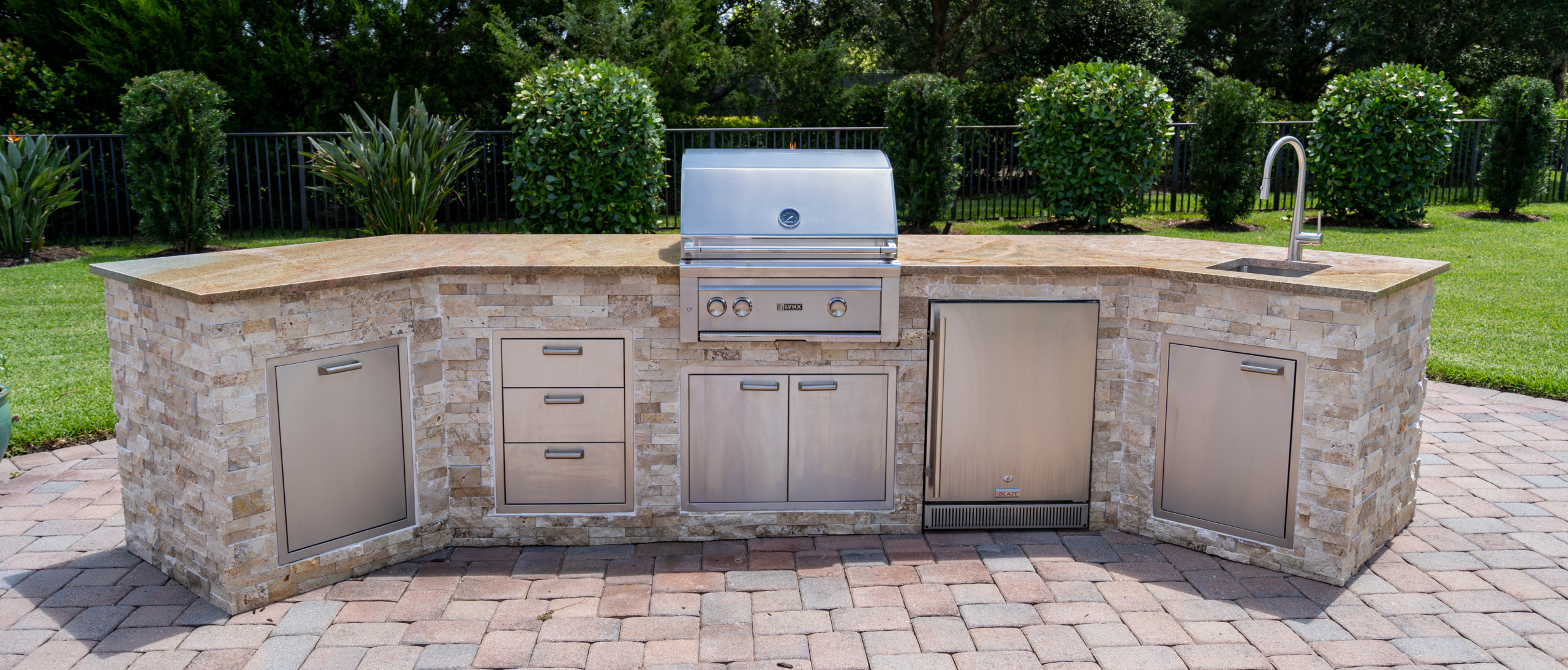 Patio kitchen – mediterranean backyard brick patio kitchen idea in Miami with no cover