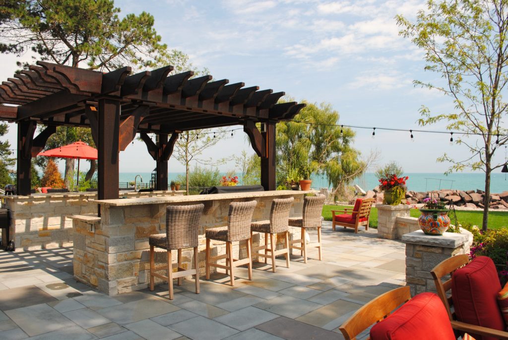Patio kitchen - mediterranean patio kitchen idea in Milwaukee with a pergola