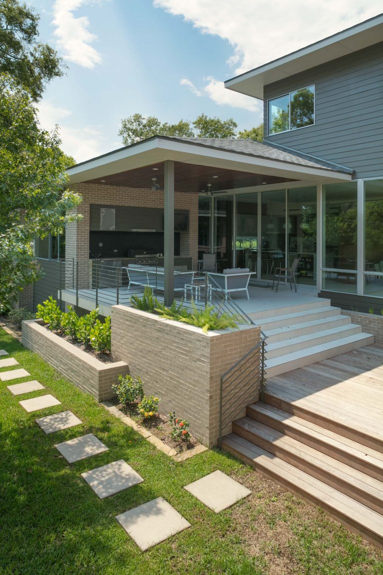 Patio kitchen - mid-sized 1950s backyard concrete paver patio kitchen idea in Houston with a roof extension