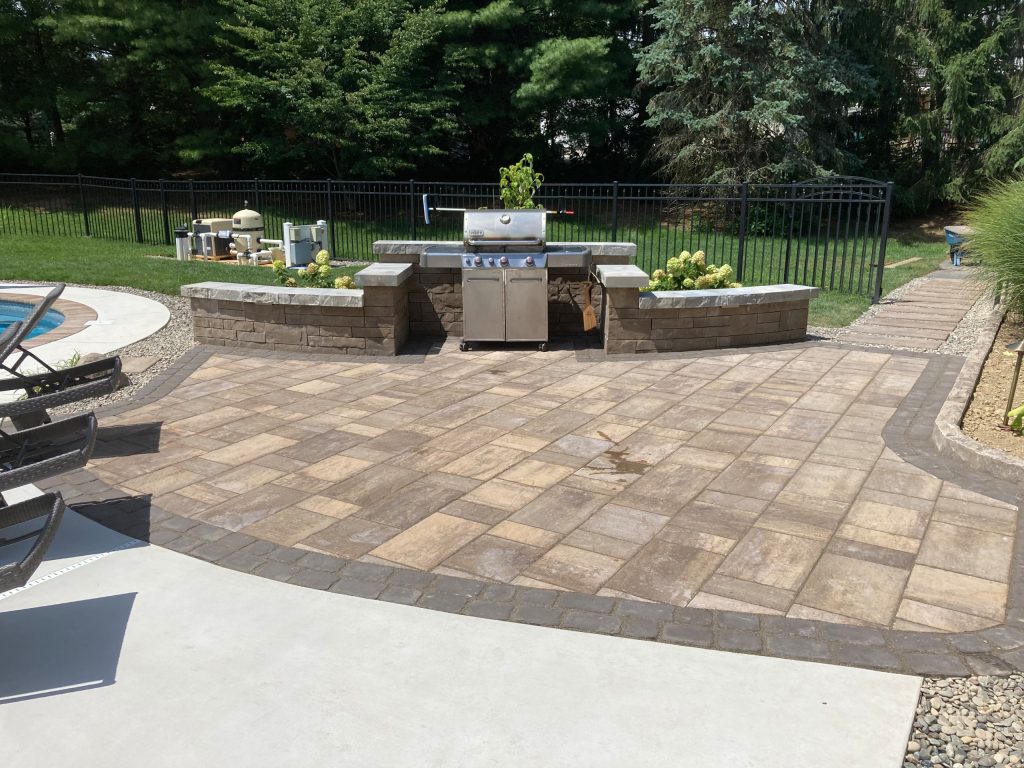 Patio kitchen - mid-sized backyard concrete paver patio kitchen idea in Other with no cover