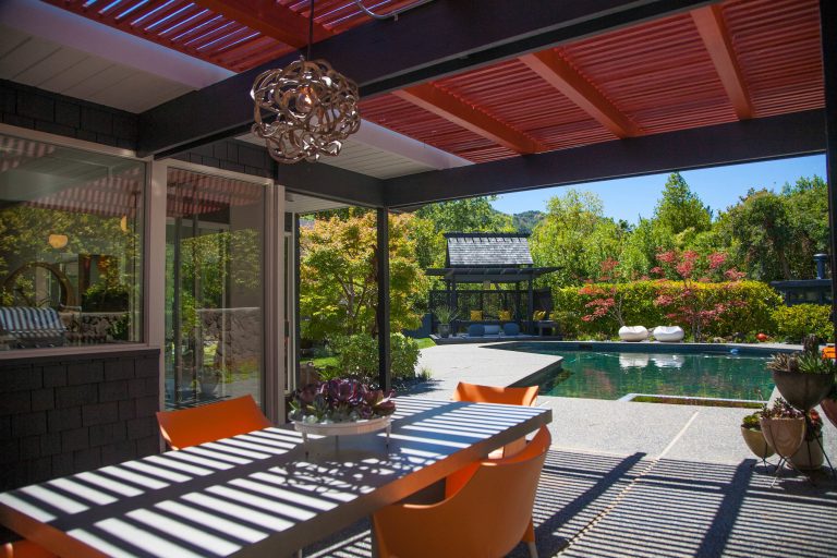 Patio kitchen - mid-sized backyard gravel patio kitchen idea in San Francisco with a roof extension