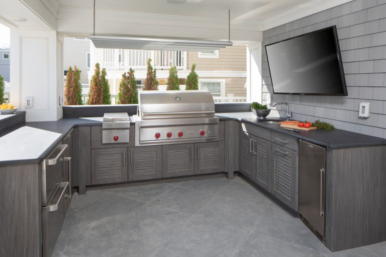 Patio kitchen - mid-sized coastal backyard concrete paver patio kitchen idea in New York with a roof extension
