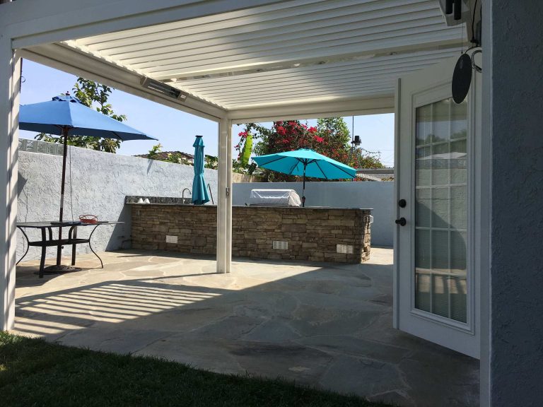 Patio kitchen - mid-sized contemporary backyard patio kitchen idea in Los Angeles with a pergola