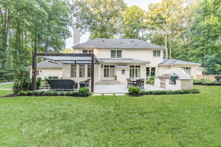 Patio kitchen - mid-sized contemporary backyard stone patio kitchen idea in DC Metro with a pergola
