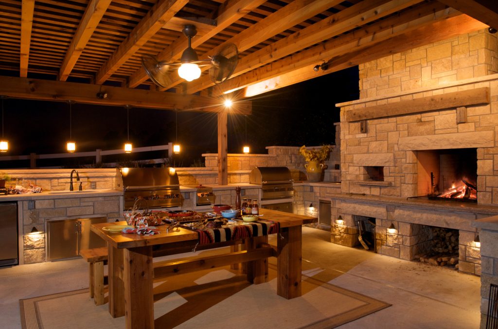 Patio kitchen - mid-sized country backyard concrete patio kitchen idea in Kansas City with a pergola