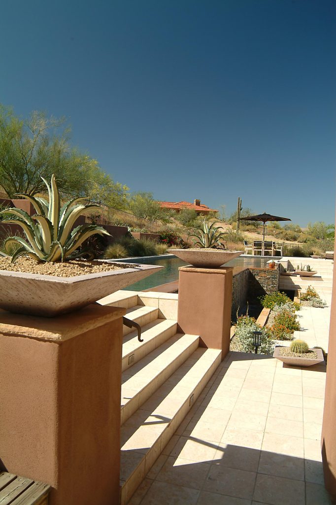 Patio kitchen - mid-sized mediterranean backyard stone patio kitchen idea in Phoenix with no cover