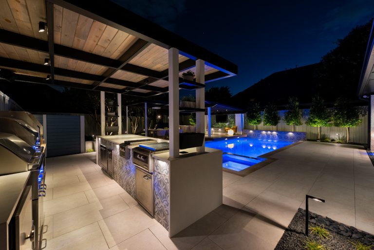 Patio kitchen - mid-sized modern backyard patio kitchen idea in Dallas with decking and an awning