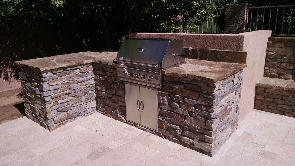 Patio kitchen - mid-sized modern backyard stone patio kitchen idea in Phoenix with no cover