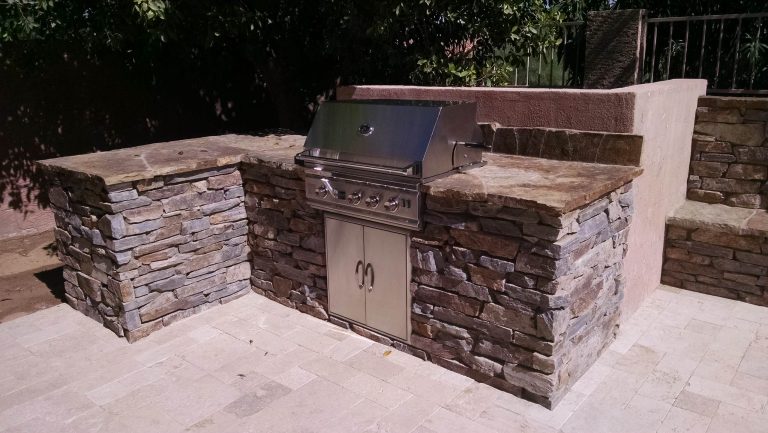 Patio kitchen - mid-sized modern backyard stone patio kitchen idea in Phoenix with no cover