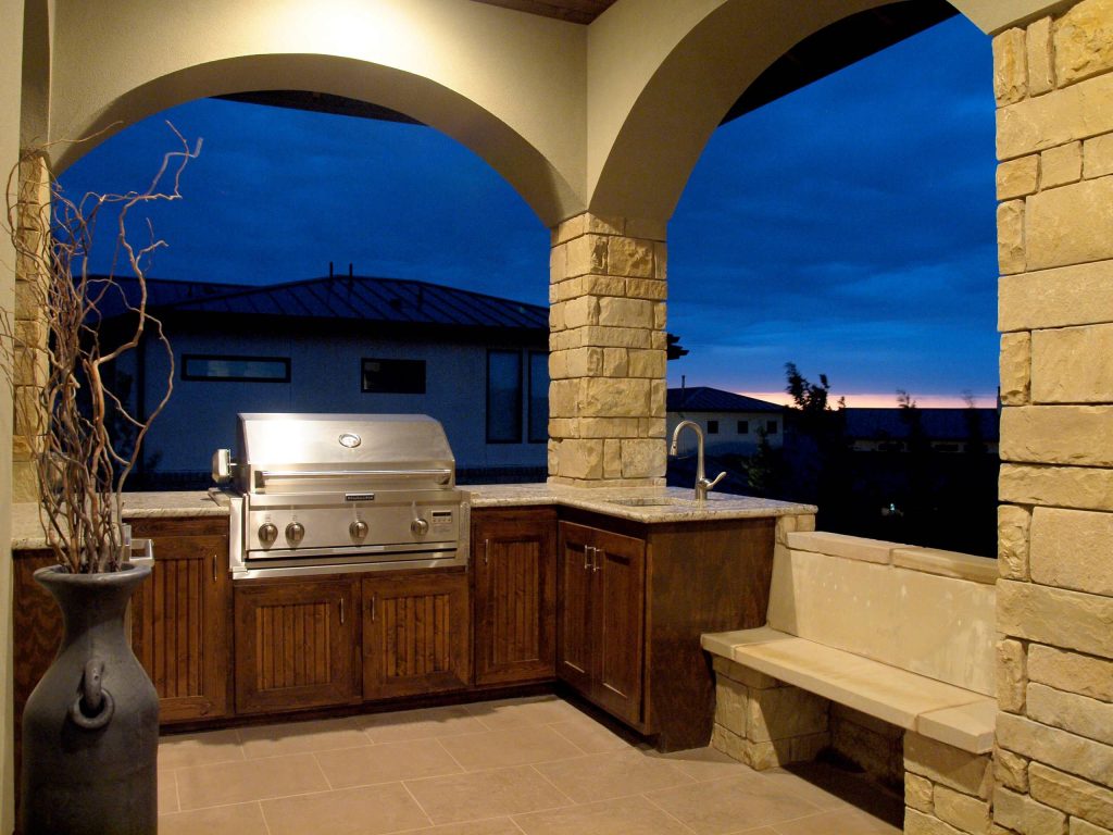 Patio kitchen - mid-sized southwestern backyard tile patio kitchen idea in Austin with a roof extension