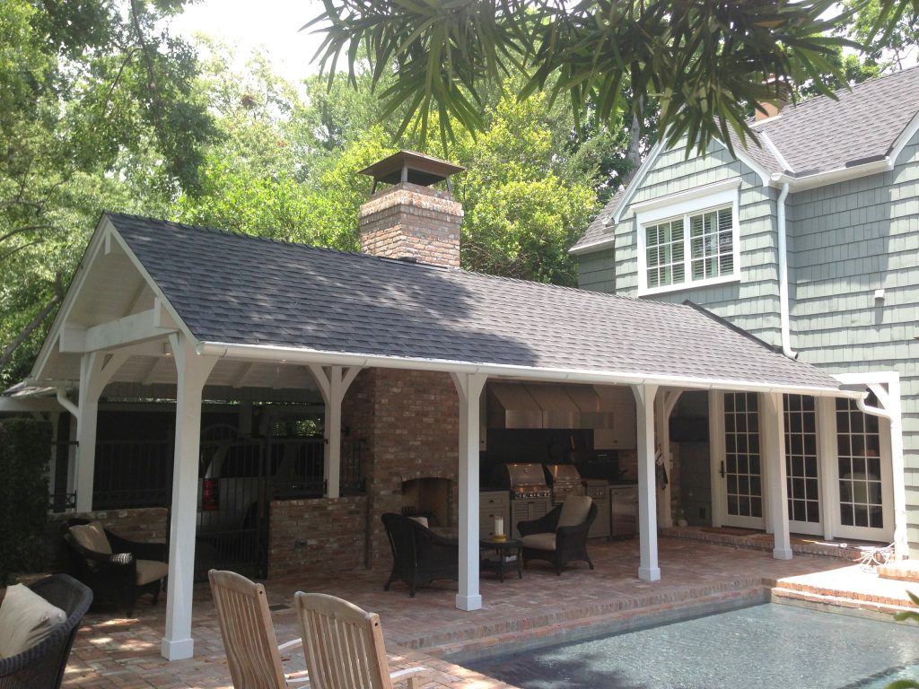 Patio kitchen - mid-sized traditional backyard brick patio kitchen idea in Houston with a roof extension