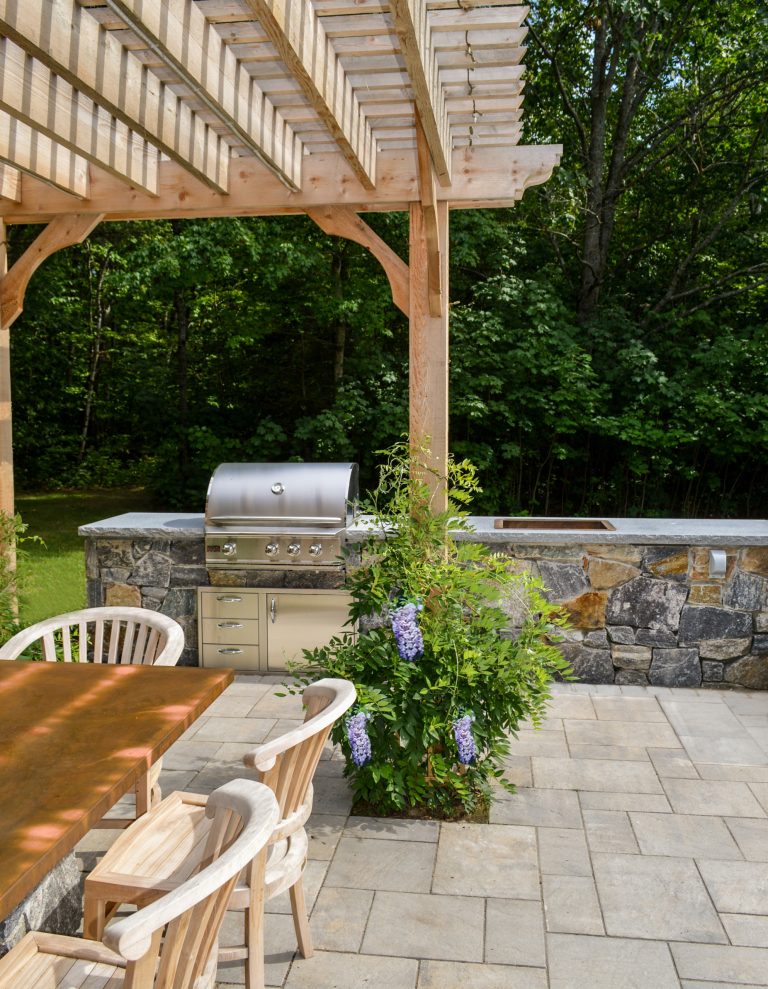 Patio kitchen - mid-sized traditional backyard brick patio kitchen idea in Portland Maine with a pergola