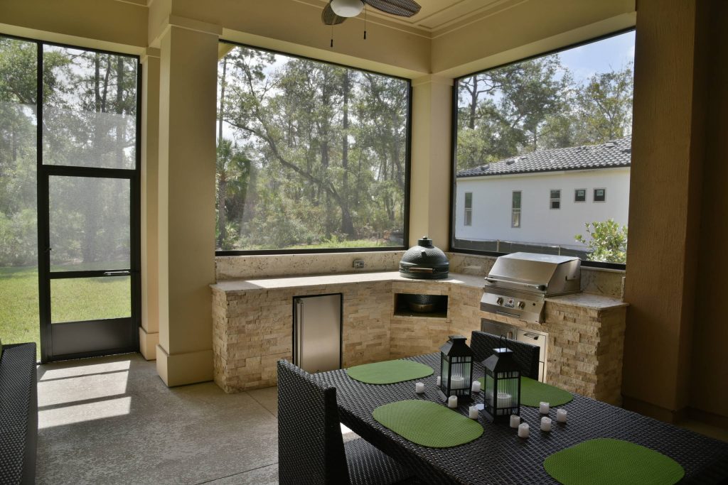 Patio kitchen - mid-sized traditional backyard concrete patio kitchen idea in Jacksonville with a roof extension