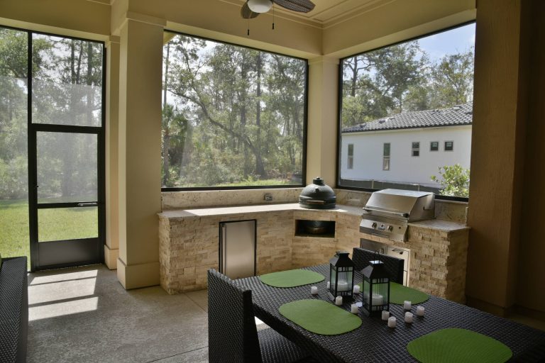 Patio kitchen - mid-sized traditional backyard concrete patio kitchen idea in Jacksonville with a roof extension