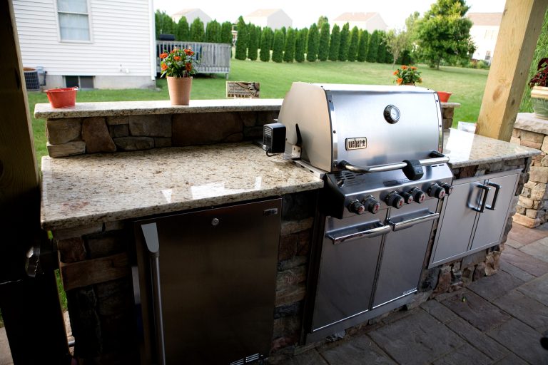 Patio kitchen - mid-sized traditional backyard concrete paver patio kitchen idea in Other with a pergola