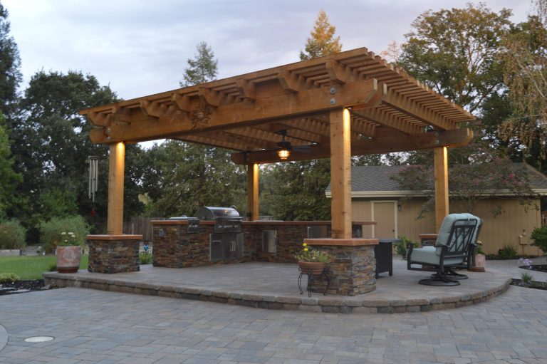 Patio kitchen - mid-sized traditional backyard concrete paver patio kitchen idea in Other with a roof extension