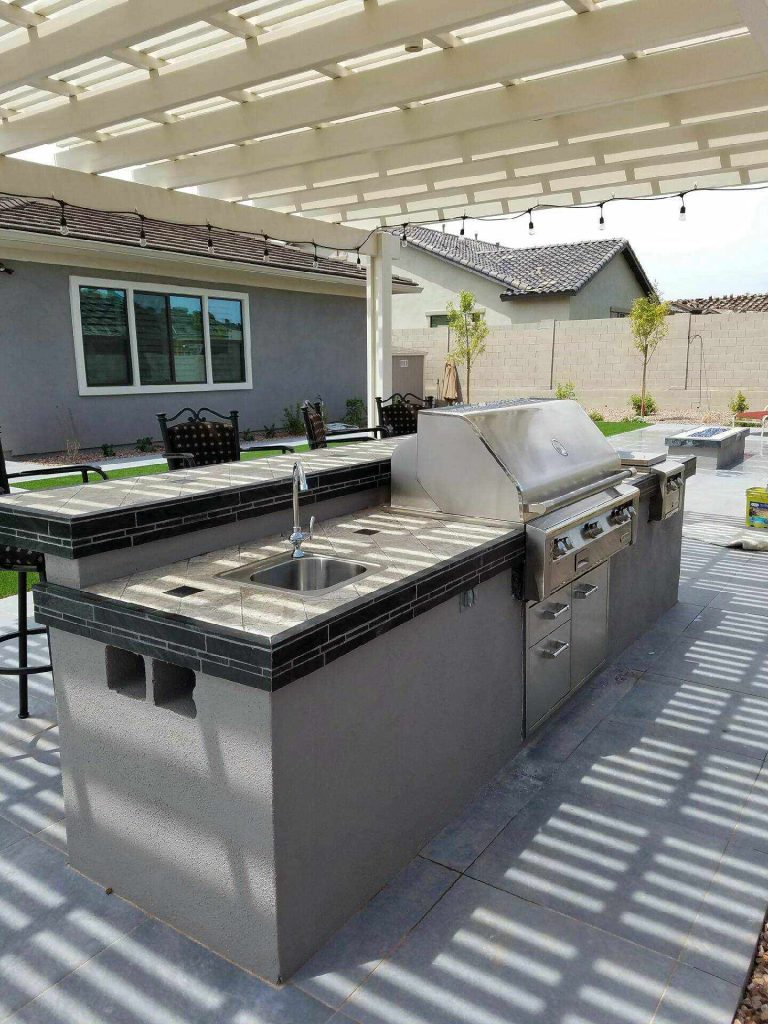 Patio kitchen - mid-sized traditional backyard concrete paver patio kitchen idea in San Diego with a pergola