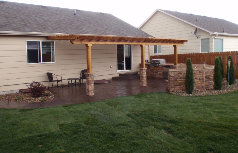 Patio kitchen - mid-sized traditional backyard stamped concrete patio kitchen idea in Denver with a pergola