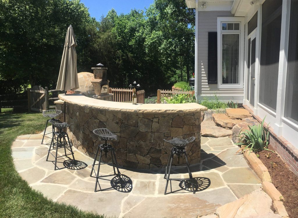 Patio kitchen - mid-sized traditional backyard stone patio kitchen idea in Charlotte with no cover