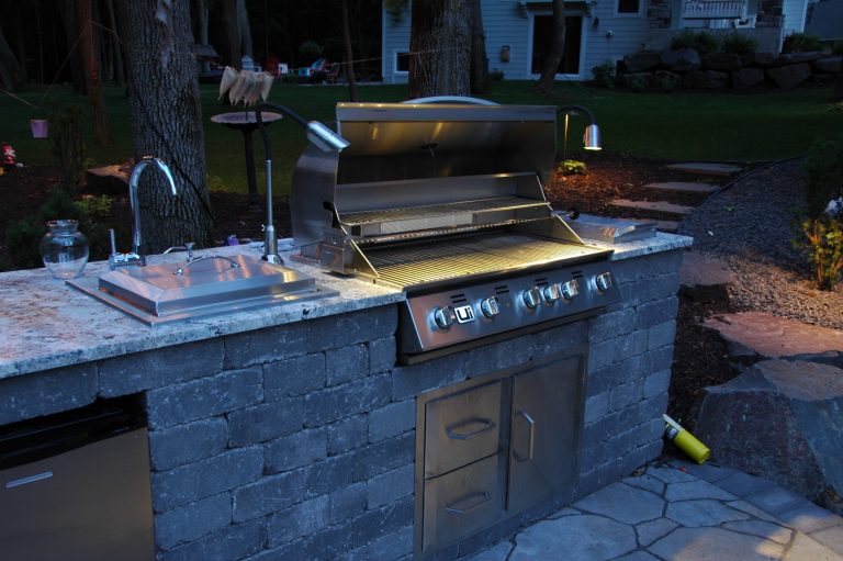 Patio kitchen - mid-sized traditional backyard stone patio kitchen idea in Minneapolis with no cover