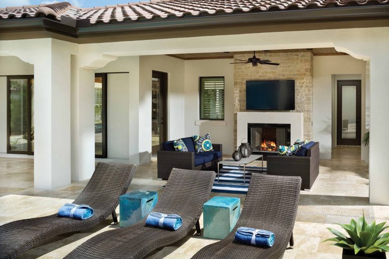 Patio kitchen - mid-sized traditional backyard stone patio kitchen idea in Orlando with a roof extension
