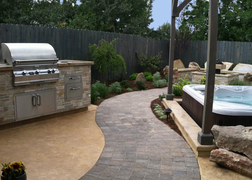 Patio kitchen - mid-sized transitional backyard brick patio kitchen idea in Boise with no cover
