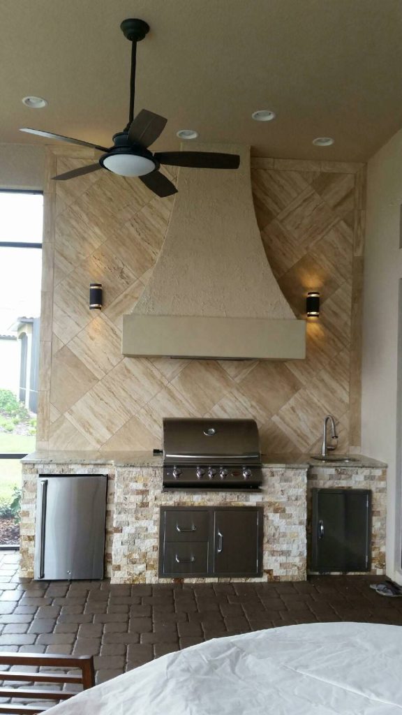 Patio kitchen - mid-sized transitional backyard brick patio kitchen idea in Tampa with a pergola