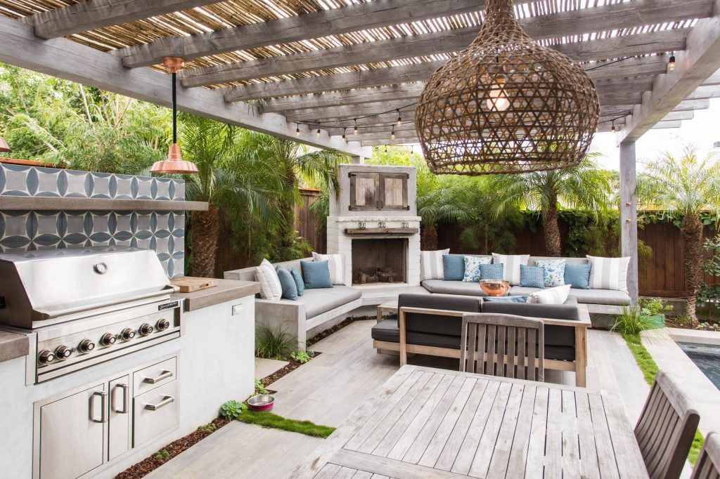 Patio kitchen - mid-sized transitional backyard concrete patio kitchen idea in Los Angeles with a pergola