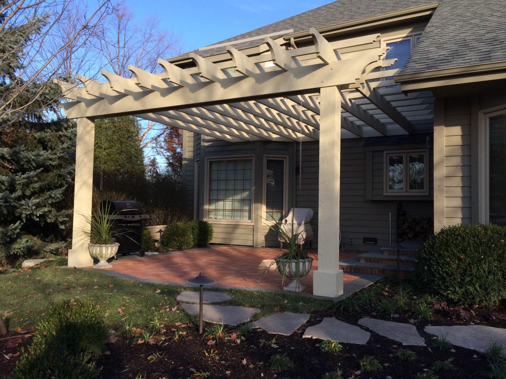 Patio kitchen - mid-sized transitional backyard stone patio kitchen idea in Chicago with a pergola