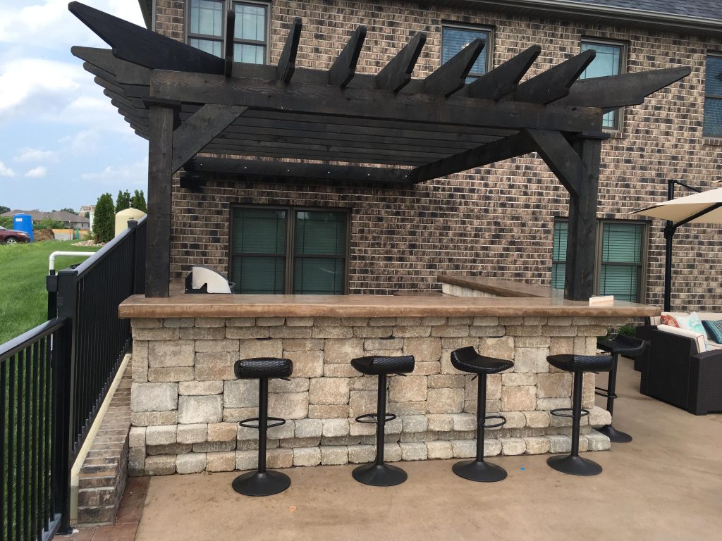 Patio kitchen - modern backyard brick patio kitchen idea in Other with a pergola