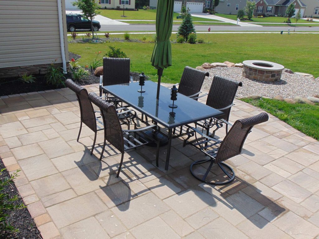 Patio kitchen - modern concrete paver patio kitchen idea in Cleveland