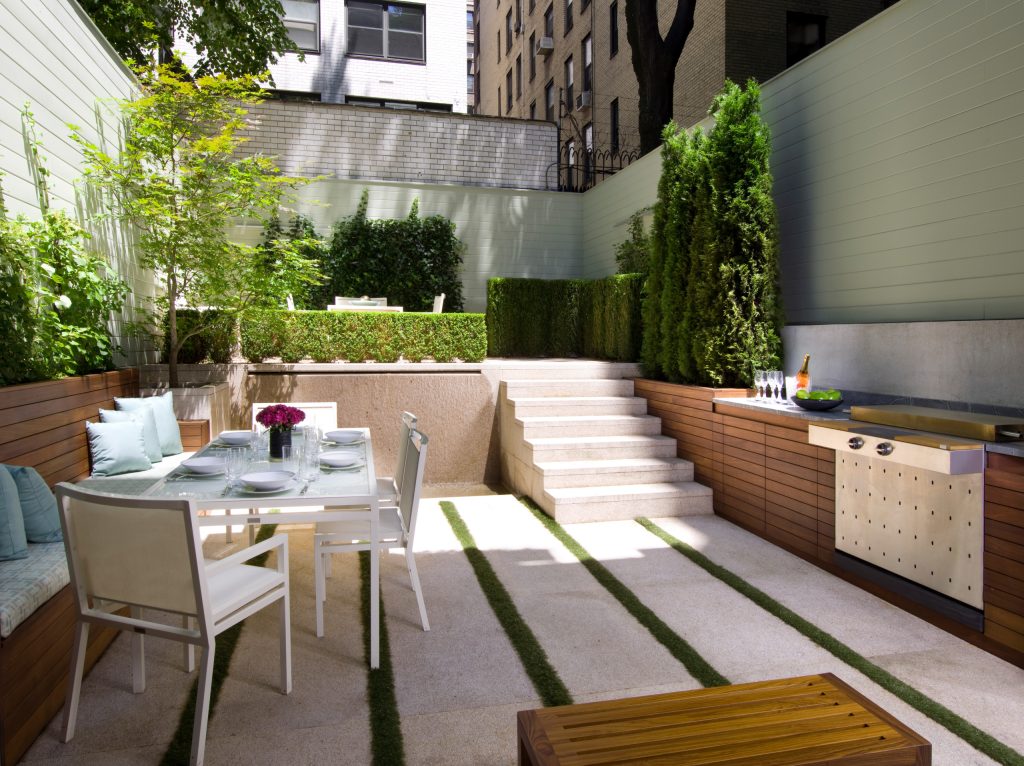 Patio kitchen - small contemporary backyard concrete patio kitchen idea in New York with no cover