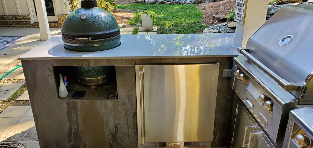 Patio kitchen - small contemporary backyard concrete patio kitchen idea in Other with a roof extension