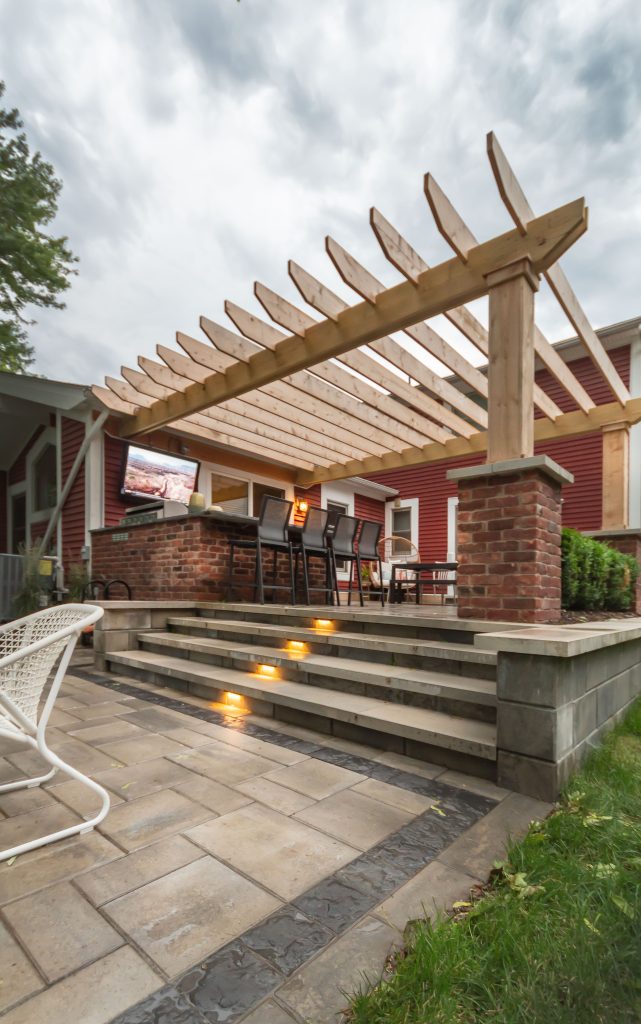 Patio kitchen - small craftsman backyard brick patio kitchen idea in Detroit with a pergola