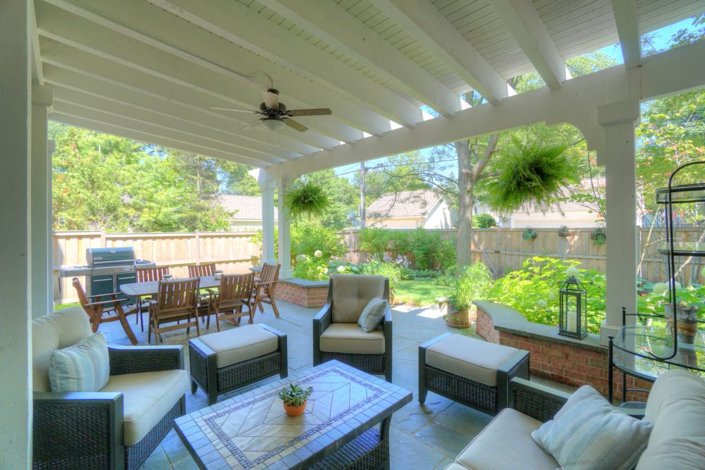 Patio kitchen - small traditional backyard stone patio kitchen idea in Chicago with a pergola