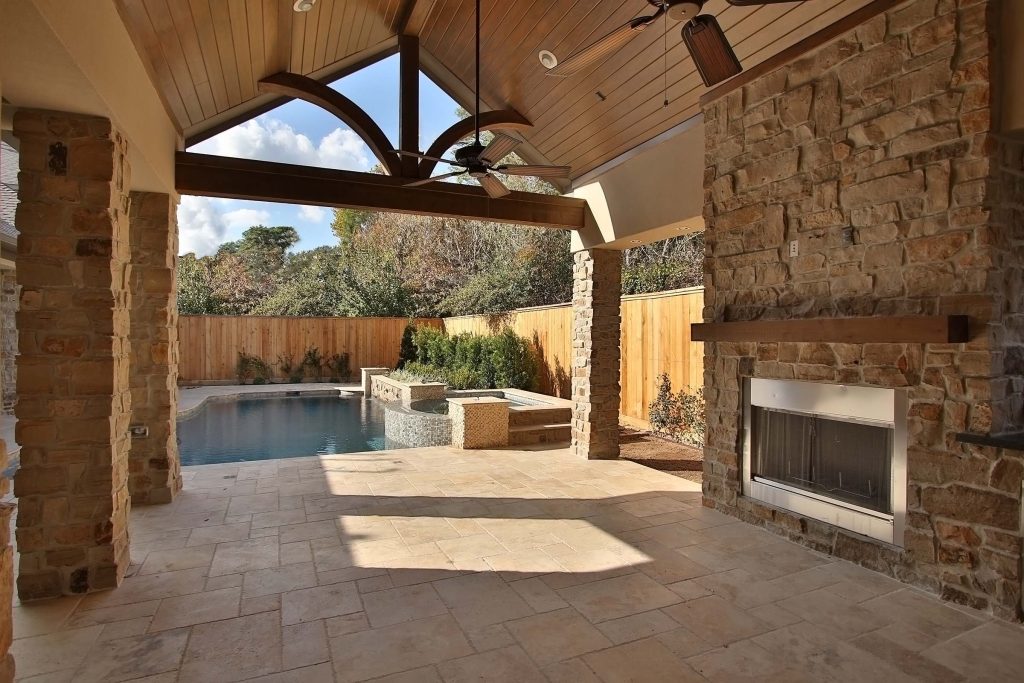 Patio kitchen - small traditional backyard stone patio kitchen idea in Houston with a roof extension