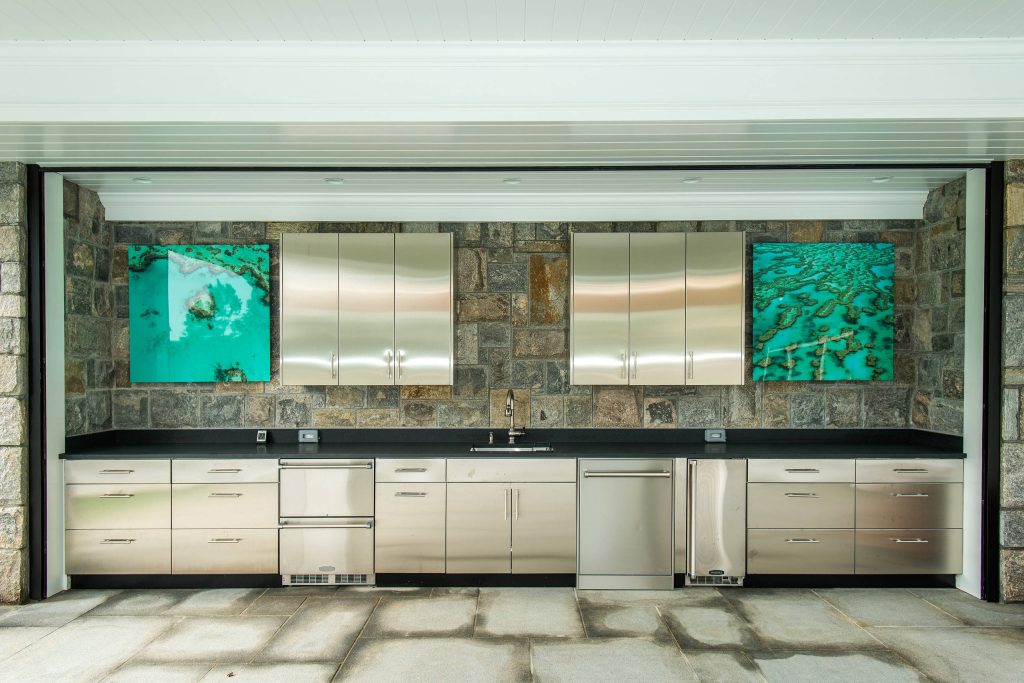 Patio kitchen - traditional backyard concrete paver patio kitchen idea in New York