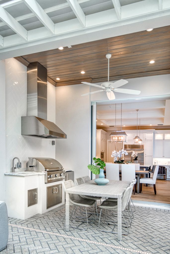 Patio kitchen - transitional backyard brick patio kitchen idea in Miami with a roof extension