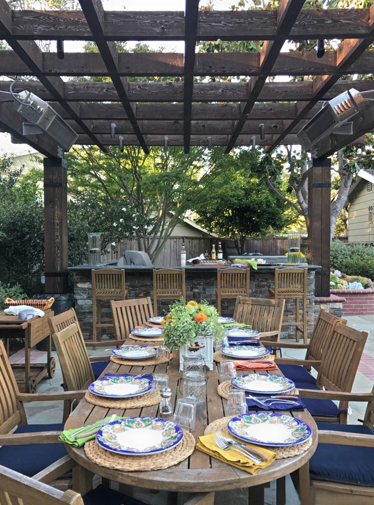Patio kitchen - transitional backyard stone patio kitchen idea in San Francisco with a pergola