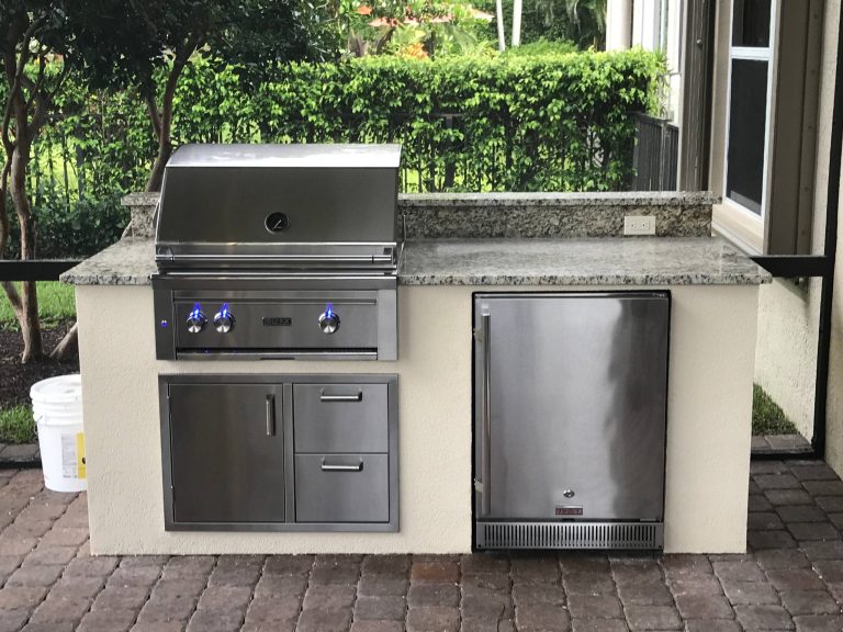 Patio kitchen - tropical backyard brick patio kitchen idea in Miami with a roof extension