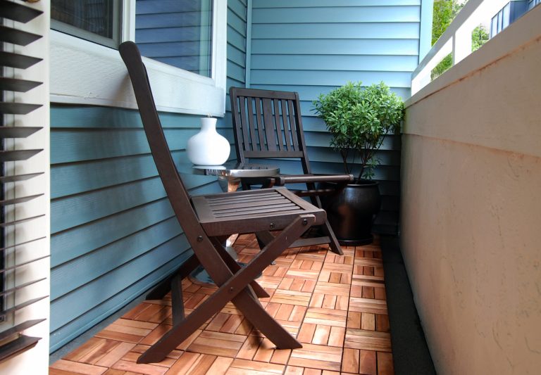 Patio underwent a transformation with the addition of two FSC-certified wood folding chairs and a recycled aluminum side table. Decking tiles, Ikea.