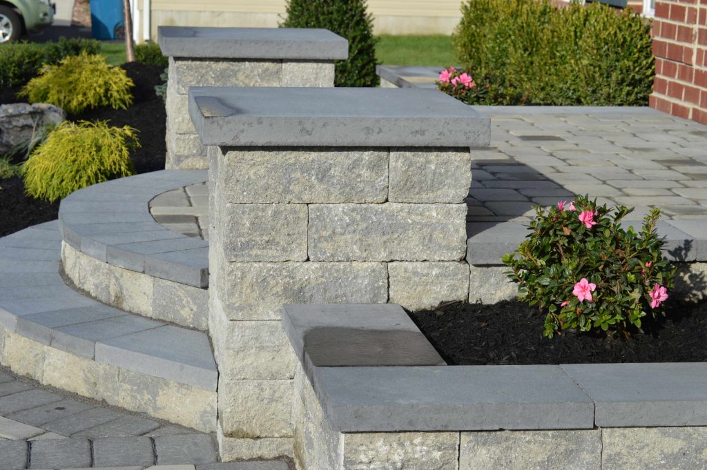 Paver walkway. Front steps with paver landing. Pillars. Landscape design.