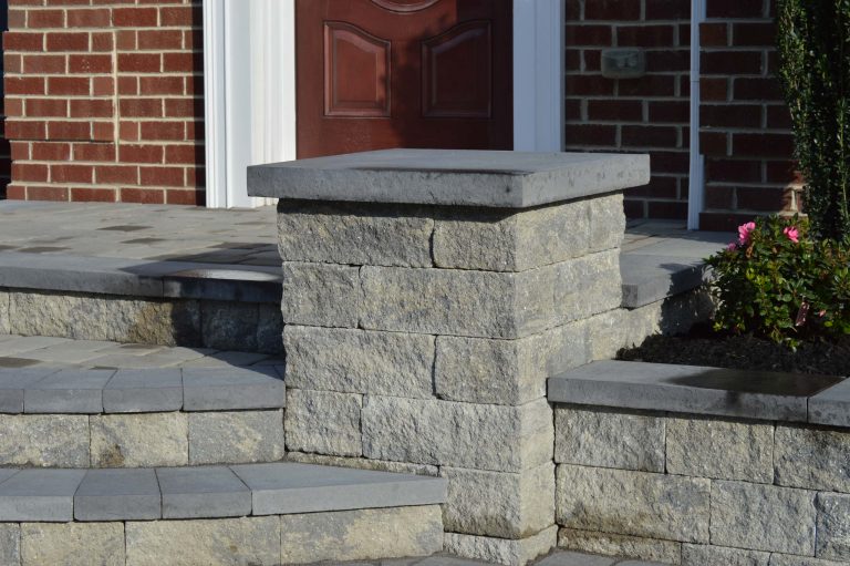 Paver walkway. Front steps with paver landing. Pillars. Landscape design.